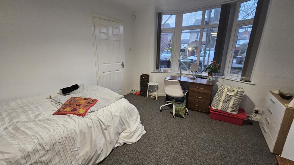 A bright and welcoming master bedroom featuring...