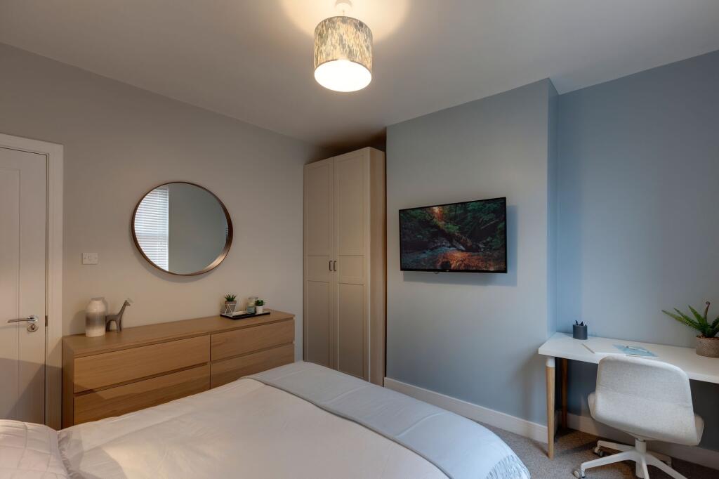 A modern, well-maintained bedroom featuring a c...