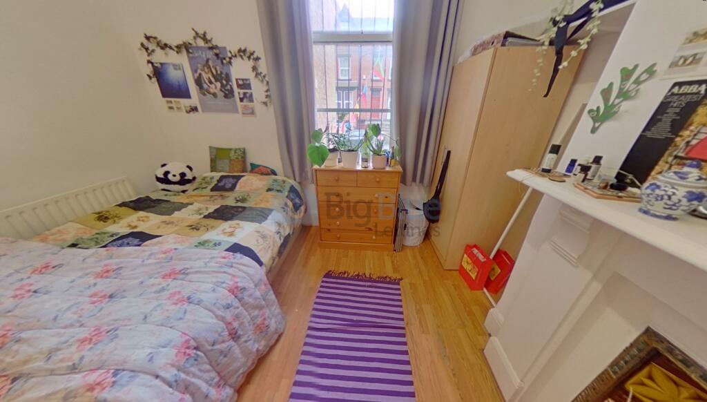 A cozy single bedroom with a comfortable bed, a...