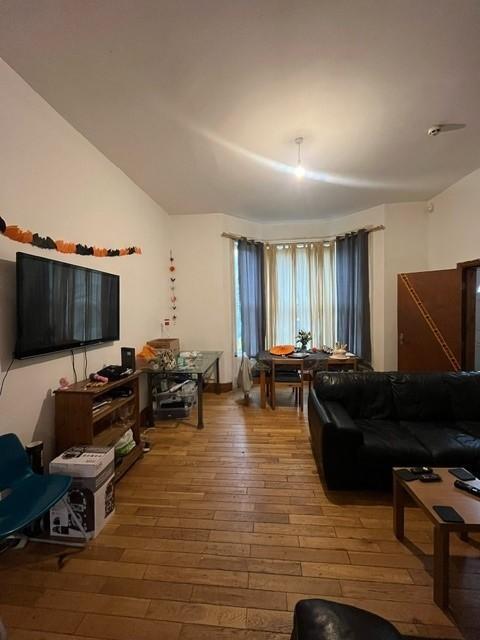 A spacious and well-lit contemporary living roo...