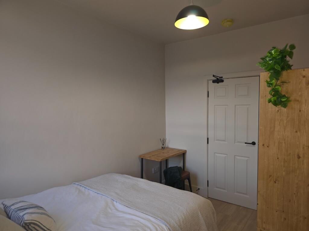 Neat furnished bedroom with a comfortable singl...