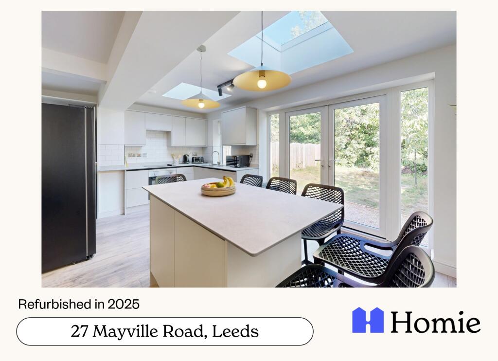 A modern, brightly lit kitchen featuring large ...