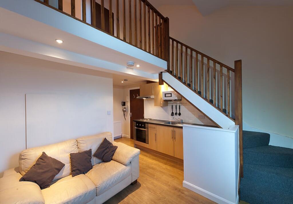 A modern living room featuring a stylish sofa, ...