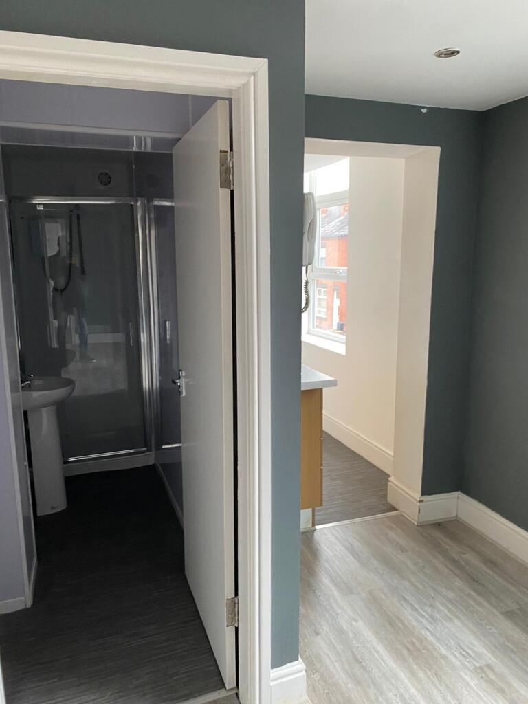 Bright and modern bathroom entrance with a clea...