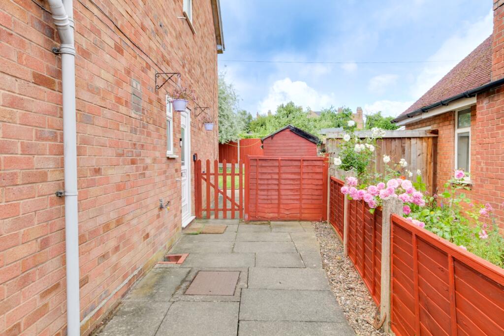 Side of house with gated area and shed