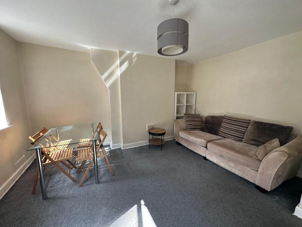 A bright and welcoming living room featuring a ...
