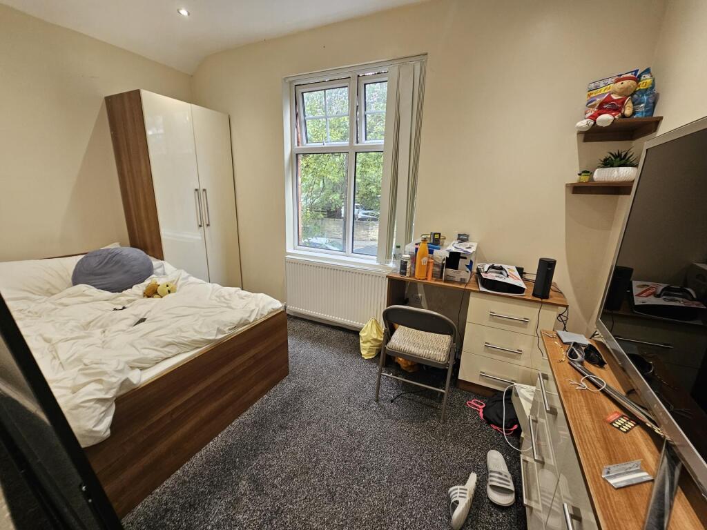 A cozy bedroom featuring a double bed, a wardro...