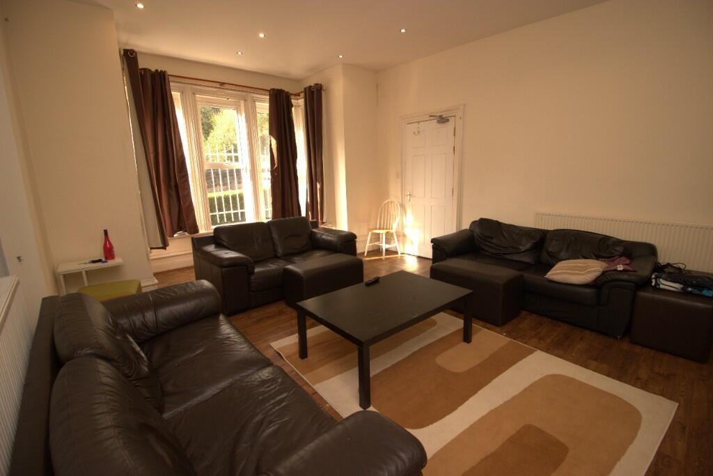 A cozy living room featuring multiple black lea...
