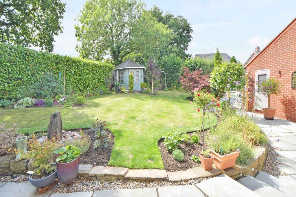 Shaped lawn with well stocked borders