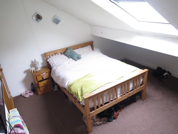 A spacious and inviting master bedroom featurin...