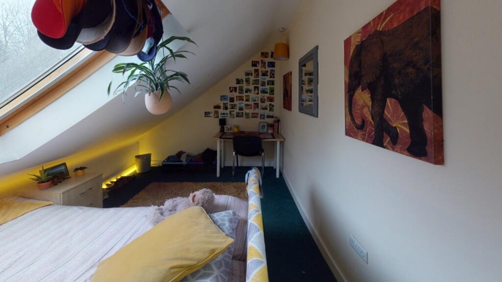 Bright and cozy master bedroom featuring a comf...