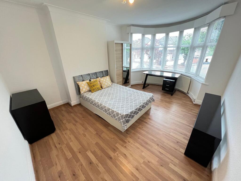 Bright and spacious master bedroom featuring a ...