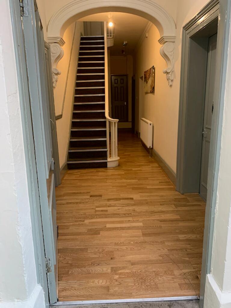 A spacious and well-maintained hallway with ele...