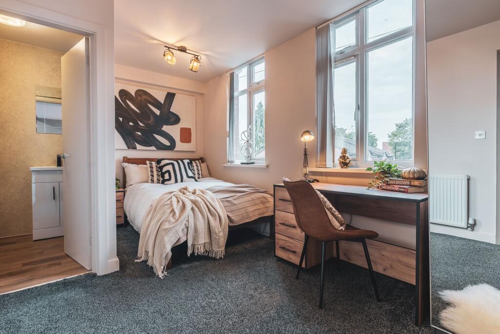 A modern and inviting bedroom featuring large w...