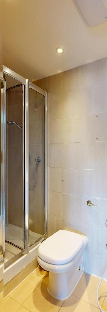 A clean and modern bathroom featuring a compact...