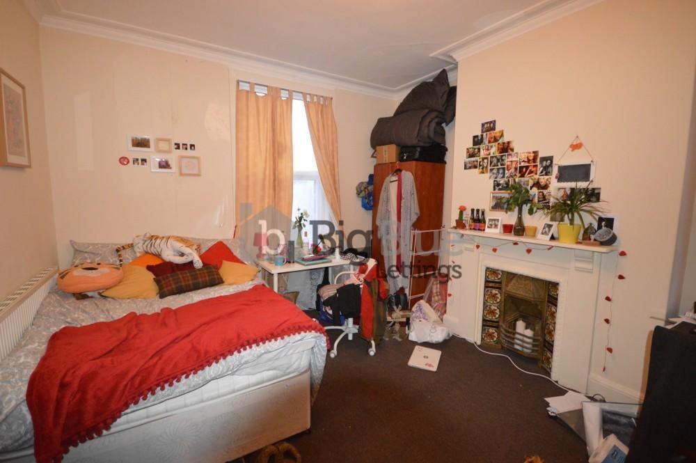 Cozy single bedroom featuring a comfortable bed...
