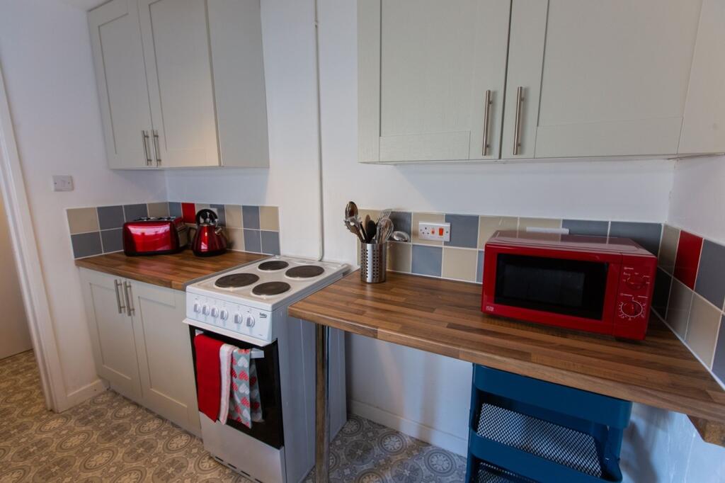 A tidy kitchen featuring essential appliances, ...