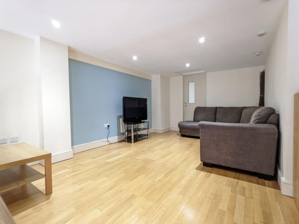 Bright, modern living room with light wood floo...