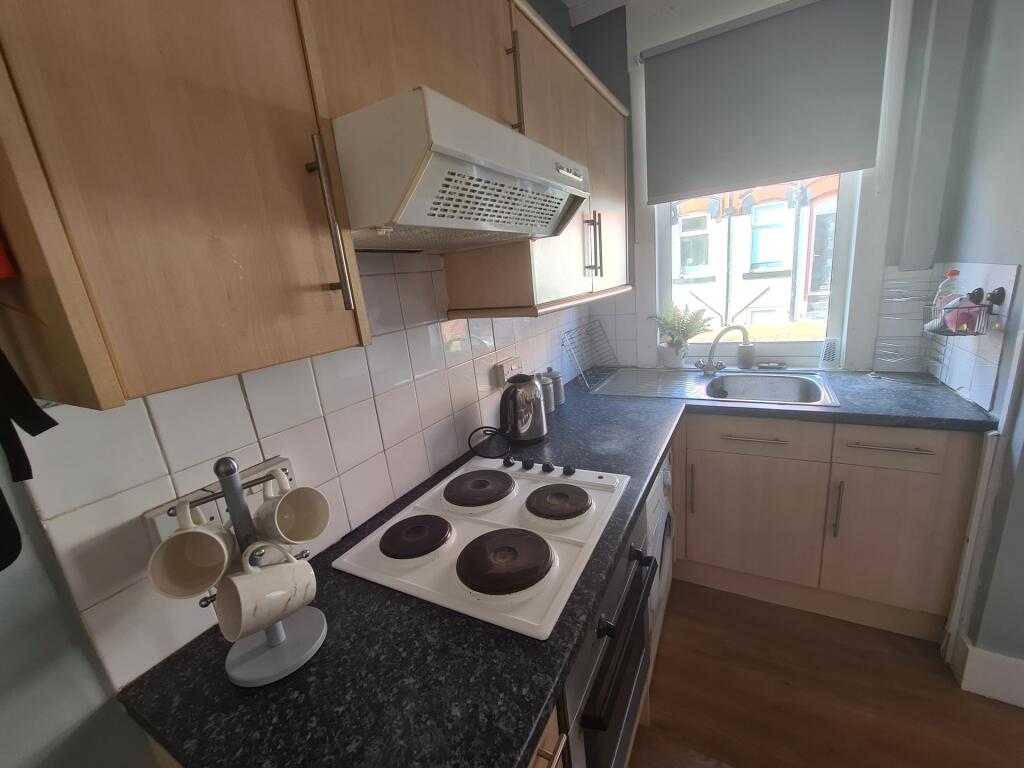 Bright and tidy kitchen space with natural ligh...