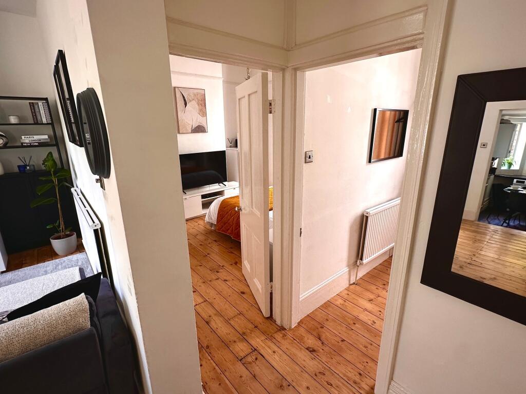 A neat and well-maintained hallway leading to a...