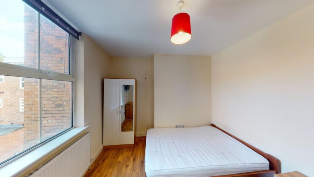 A spacious and well-lit double bedroom featurin...