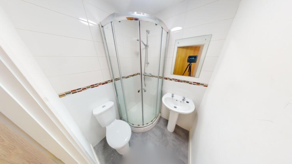 Bright and modern bathroom featuring a curved g...