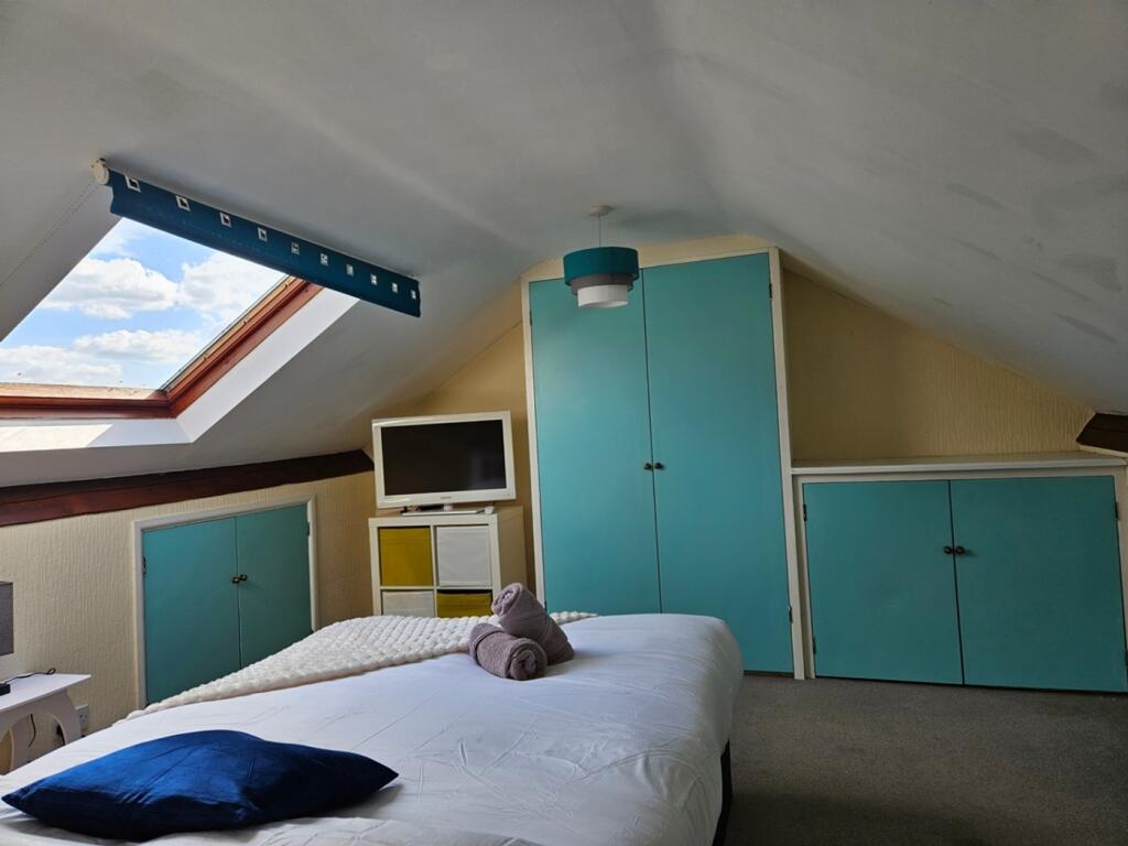 A bright and inviting double bedroom with ample...