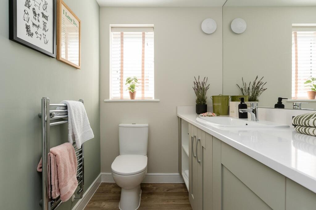 The downstairs cloakroom has space for the washing machine and ample storage