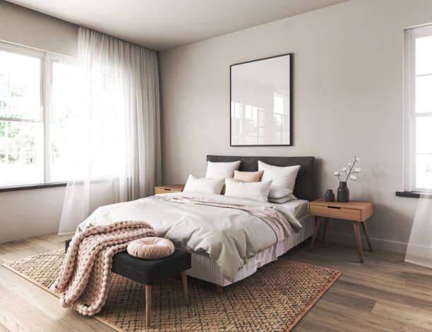 A bright and airy master bedroom featuring a co...