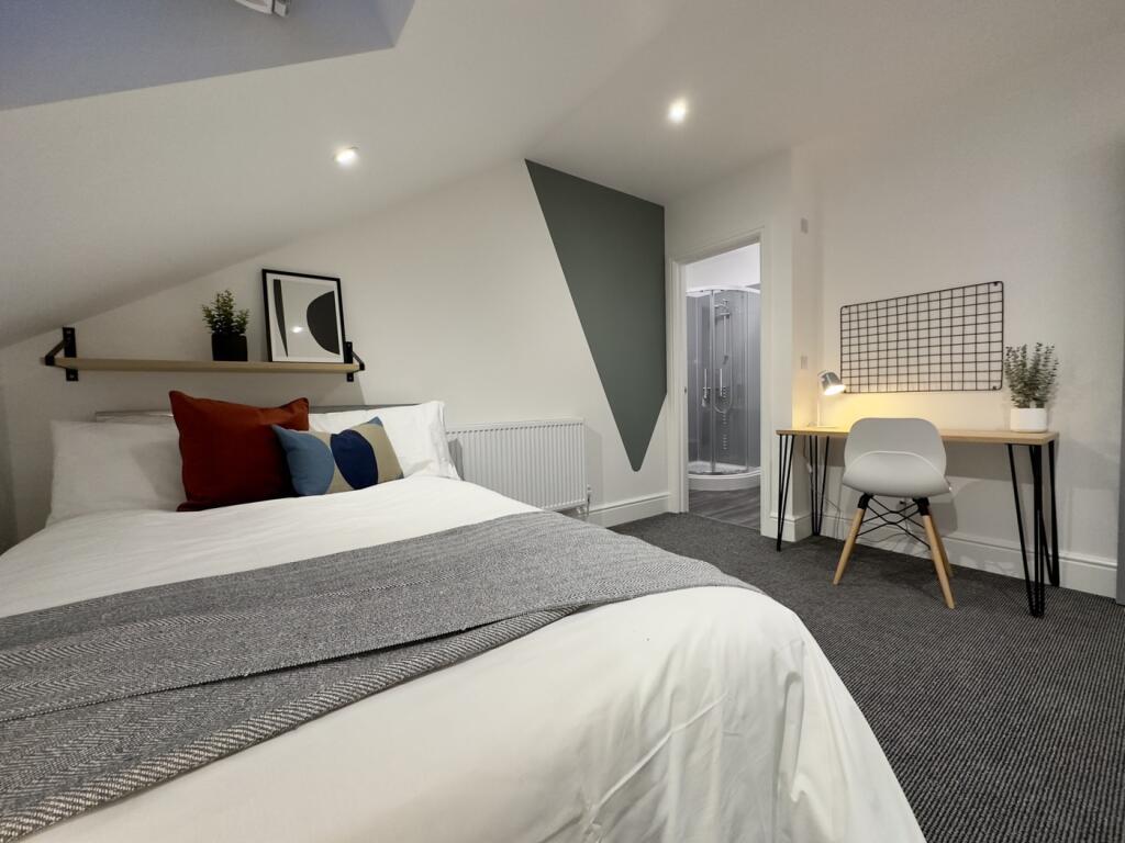 A spacious and well-lit large double bedroom wi...