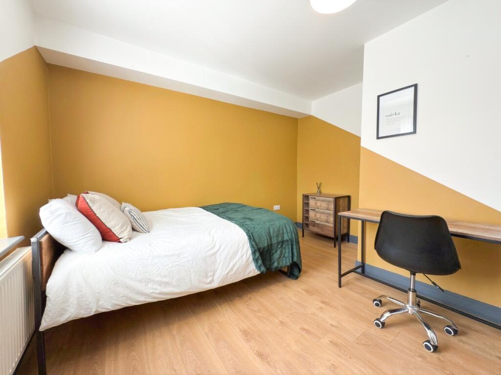 Bright, neatly presented bedroom with a comfort...