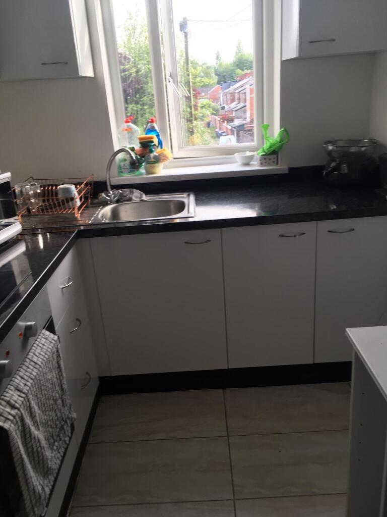 Bright and tidy kitchen with a large window pro...