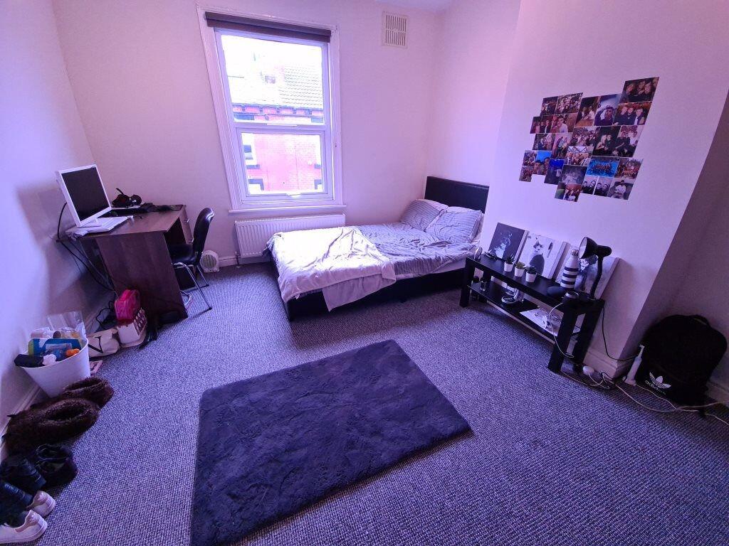 Cozy single bedroom featuring a comfortable bed...