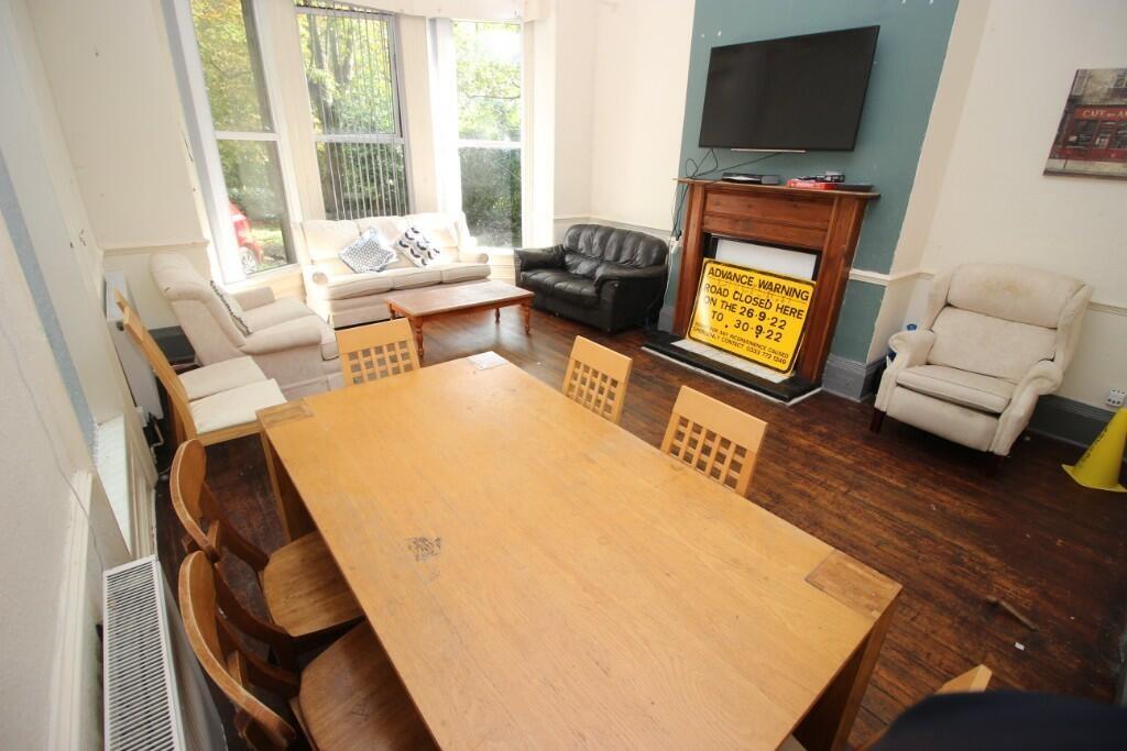 A spacious and inviting living room featuring a...
