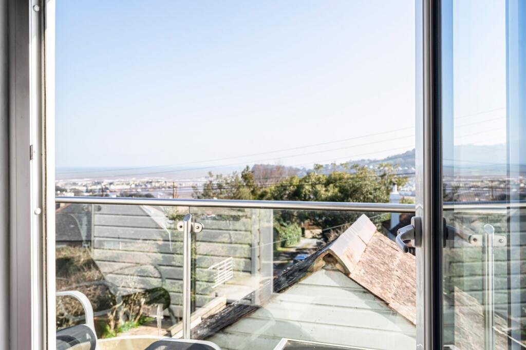 Views from main bedroom onto balcony and out to sea