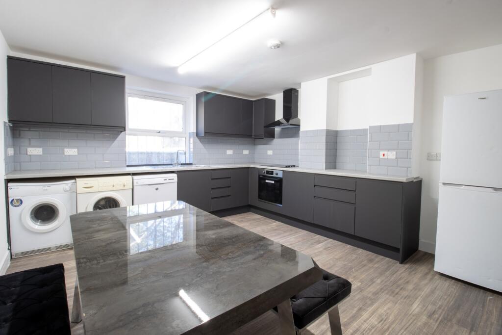 Modern and well-maintained kitchen featuring sl...
