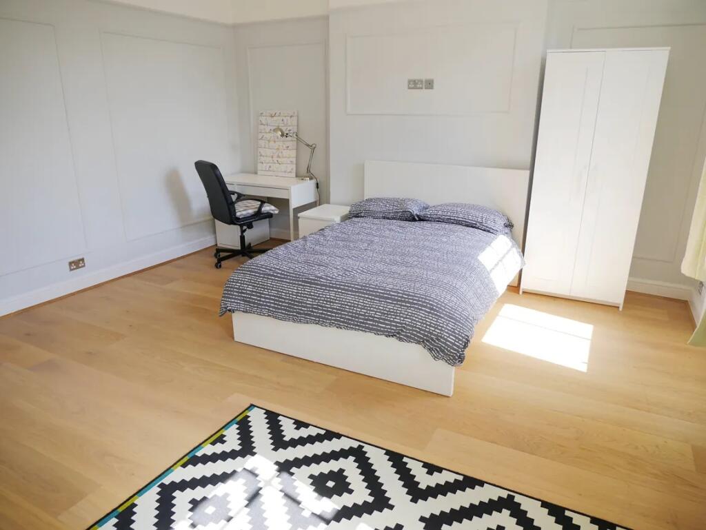 Bright and spacious master bedroom featuring a ...