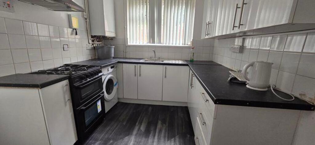 A bright and tidy kitchen with ample space for ...