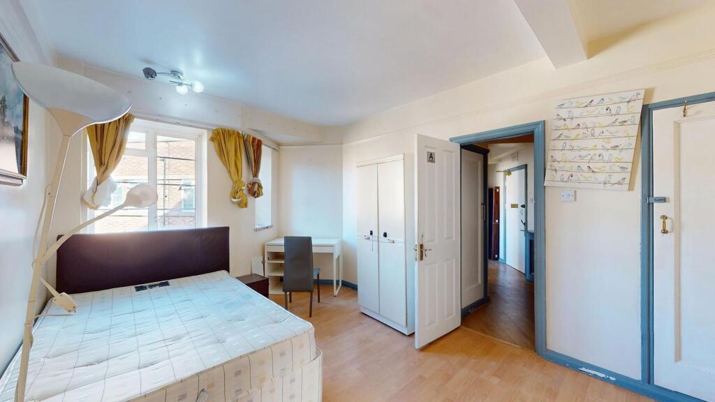 A bright and cozy bedroom with two windows prov...