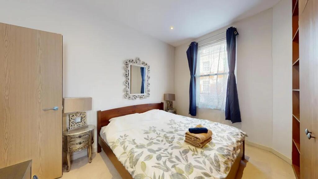 Bright and welcoming master bedroom with a larg...