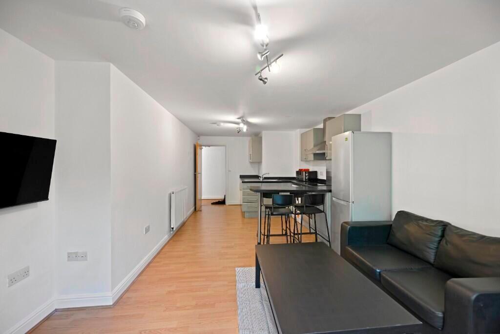 A modern, well-lit living room featuring a comf...