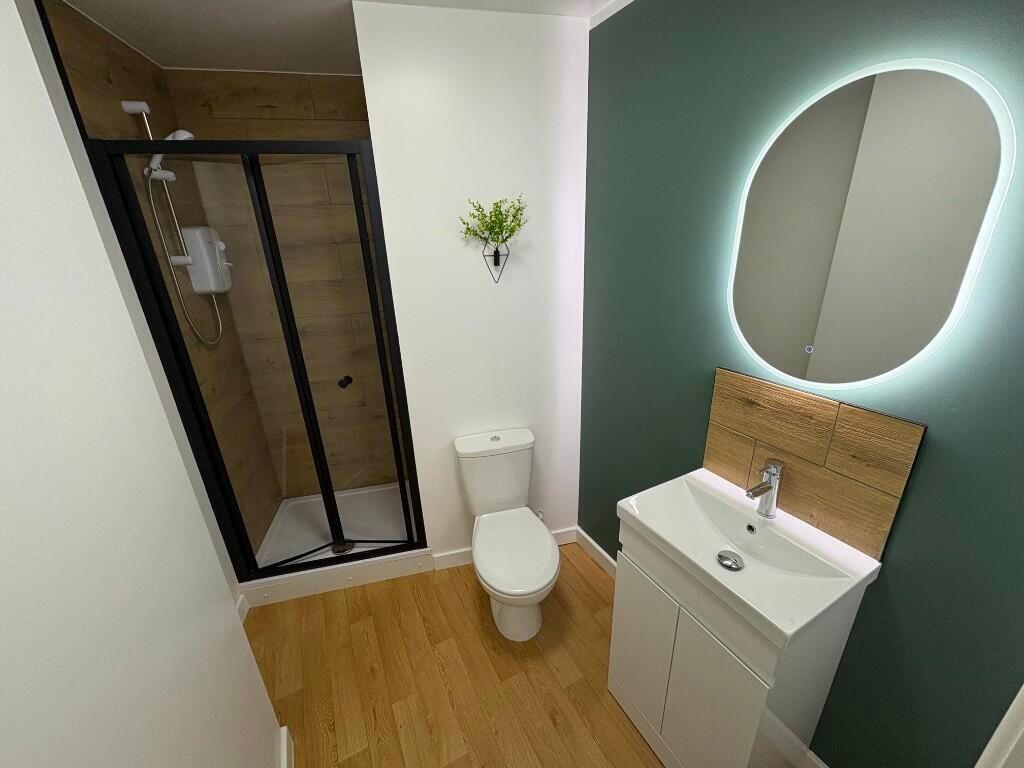 A modern bathroom featuring a stylish walk-in s...