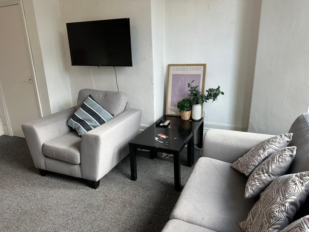 A modern and cozy living room with two comforta...