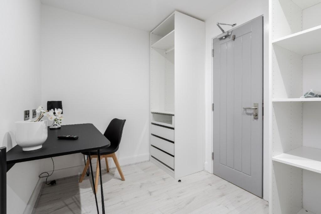 A tidy and well-lit small storage area, perfect...