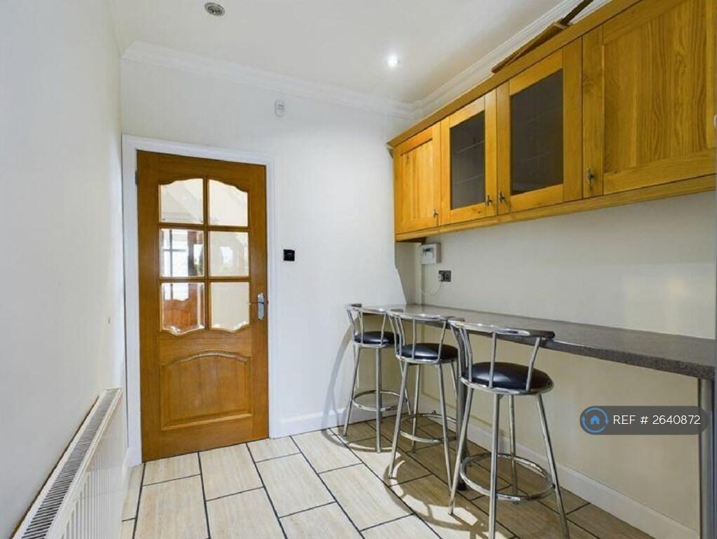 Diner In Long Spacious Kitchen With Chairs