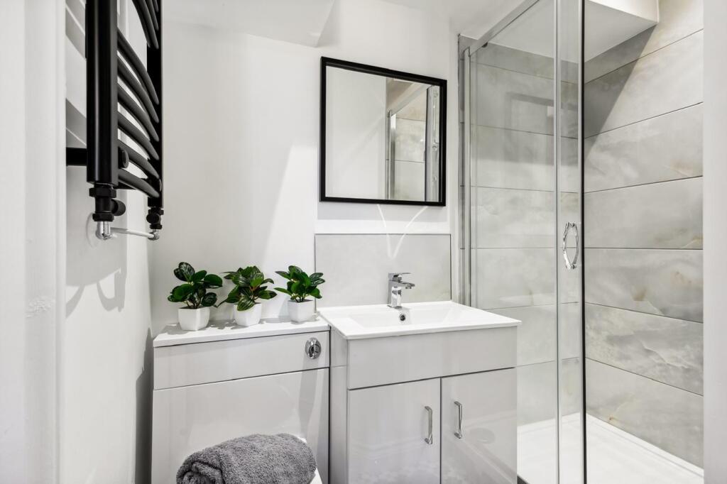 This elegantly designed bathroom features a spa...