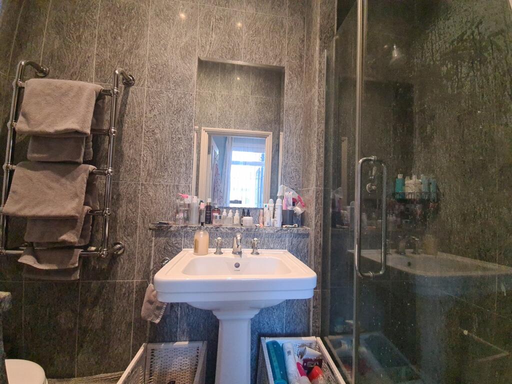 A modern bathroom with a large sink and ample s...