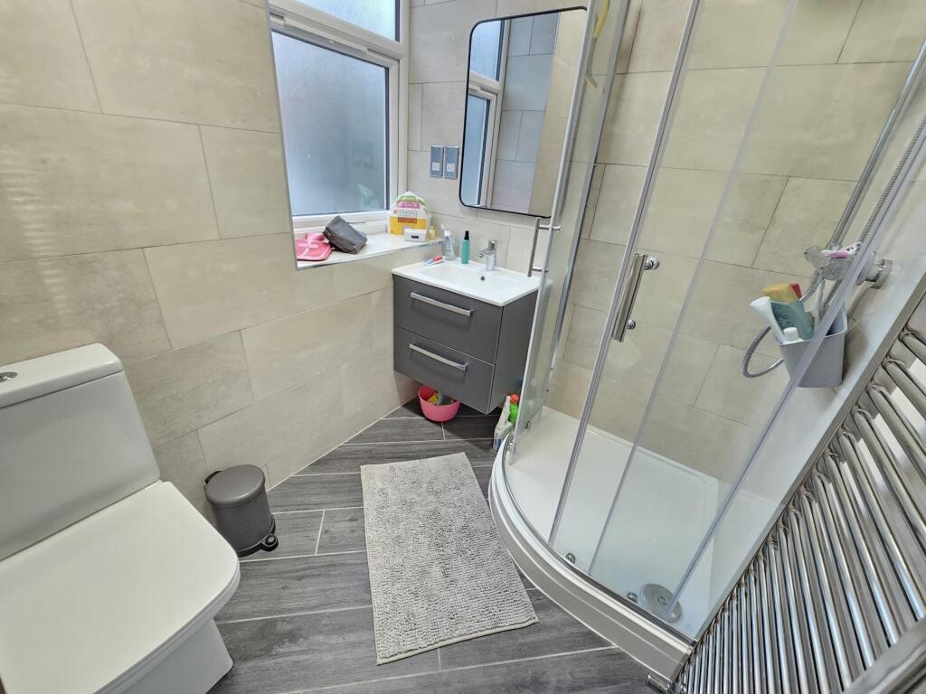 Bright and modern bathroom featuring a curved g...