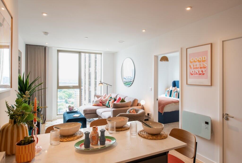A bright and stylish living room with large flo...