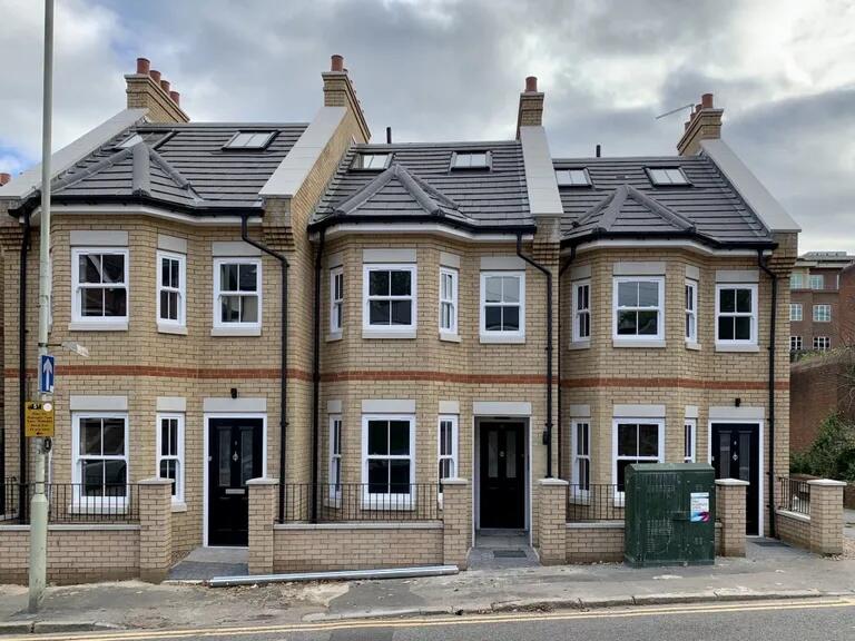 A modern terraced house with a neat brick façad...